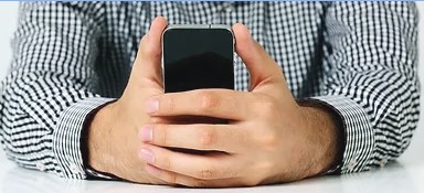 Close-up of a person holding a cell phone.