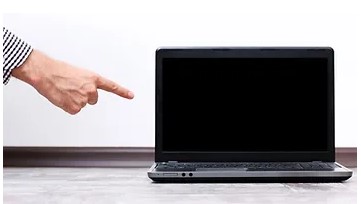 An outstretched arm pointing at a laptop.