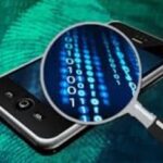 Cellphone with a magnifying glass over it looking at digital information on the phone