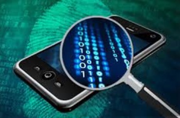 Cellphone with a magnifying glass over it looking at digital information on the phone